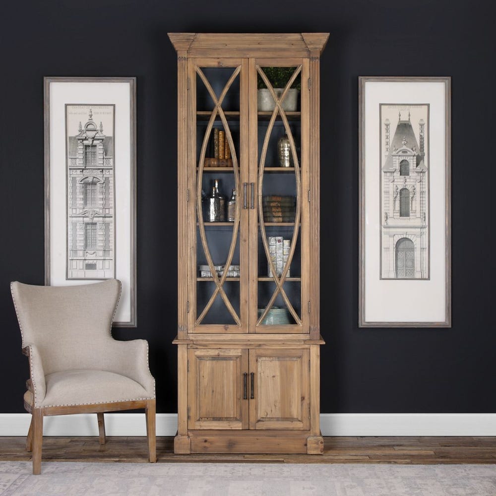 Display cabinet styled beside a chair and artwork