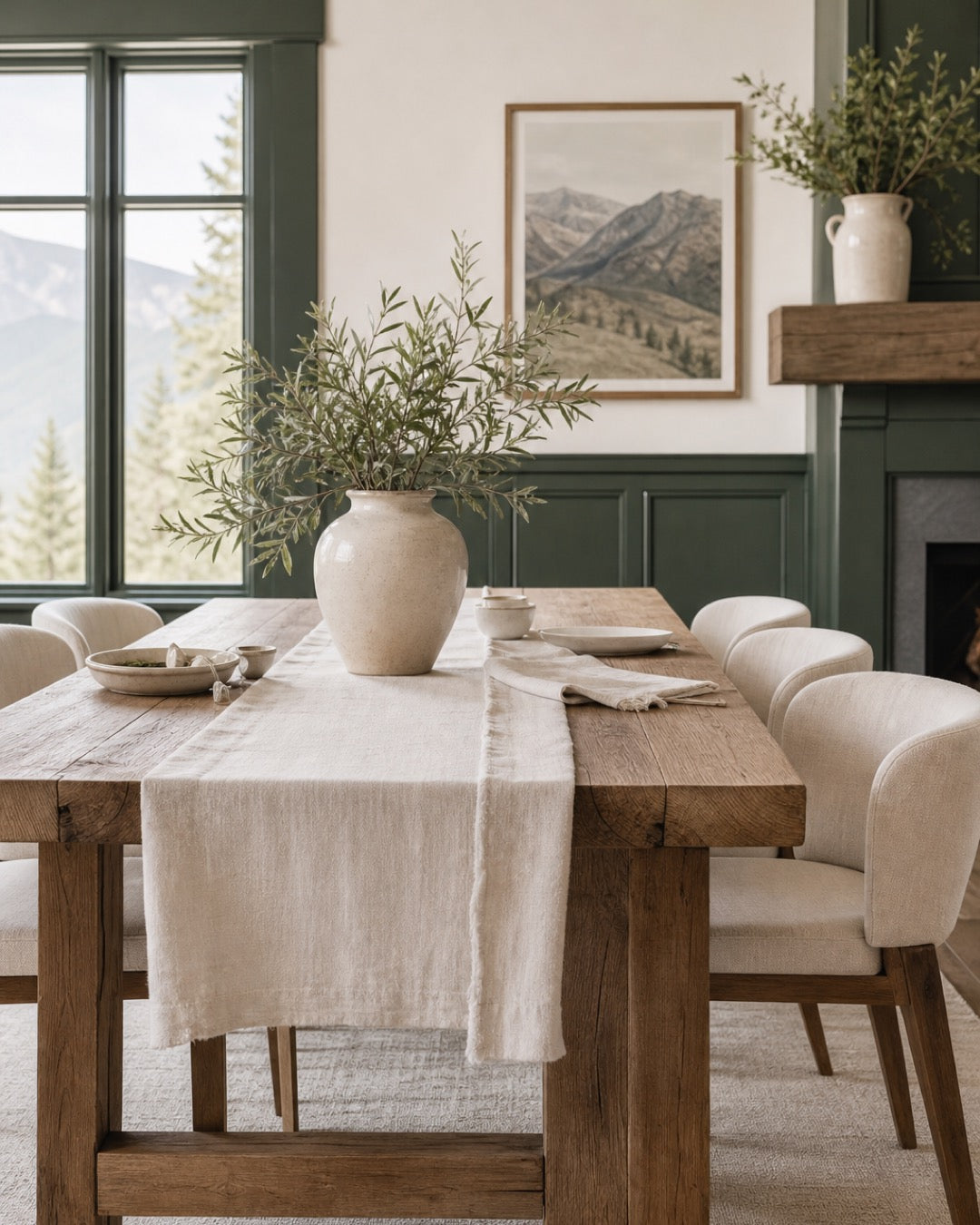 Refined dining room with reclaimed oak table, cream textiles, and green trim