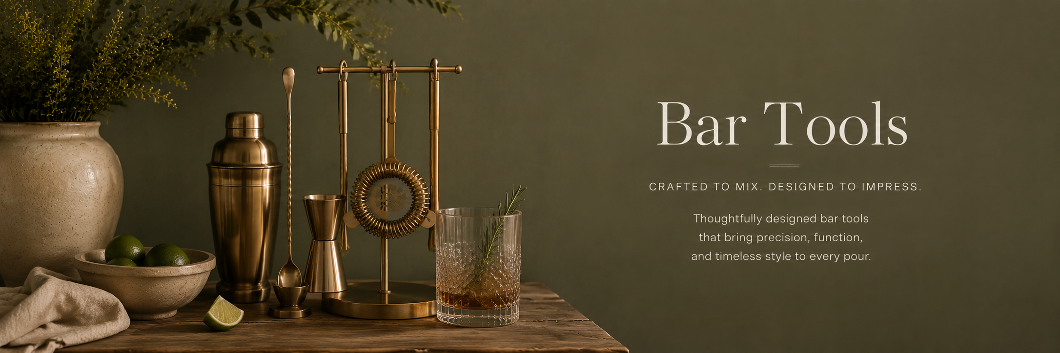 Moody editorial bar setup with brass cocktail tools, shaker, glassware, and warm olive tones