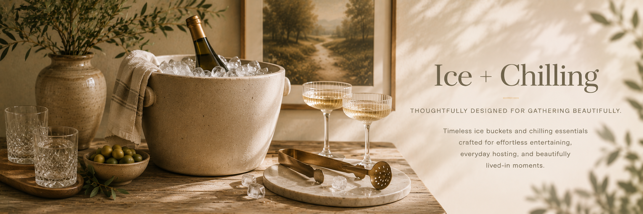 Editorial-style entertaining setup with ice bucket, chilling accessories, glassware, and warm neutral styling