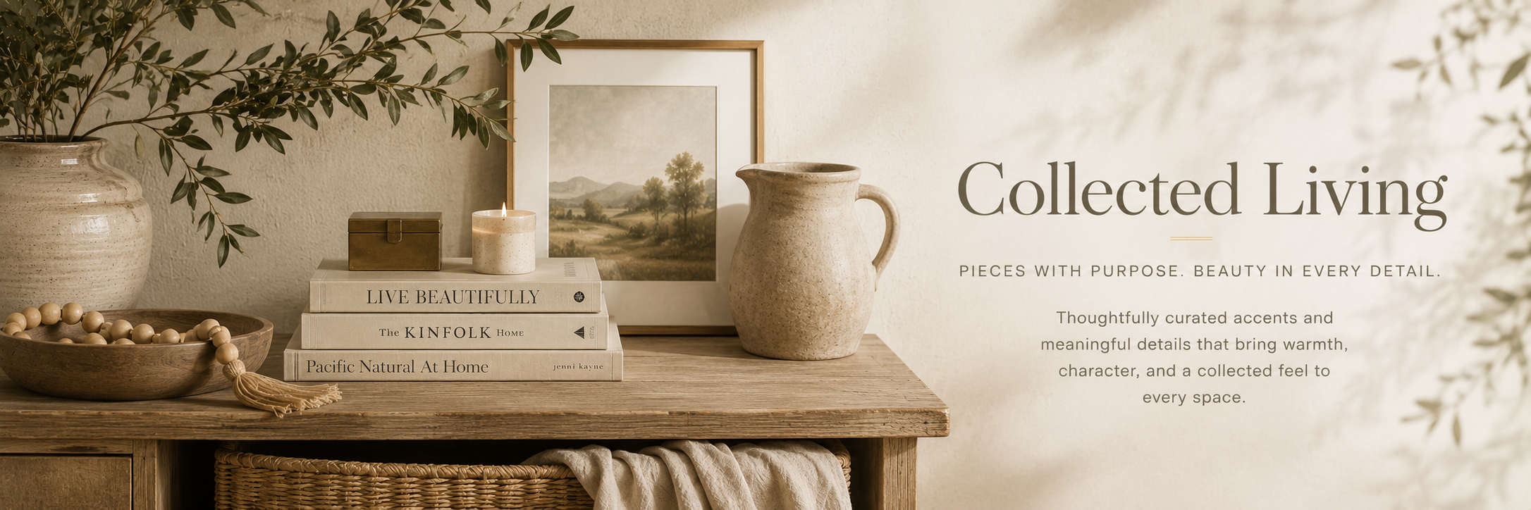 Warm neutral collected living vignette with pottery, books, wood textures, greenery, and editorial home styling