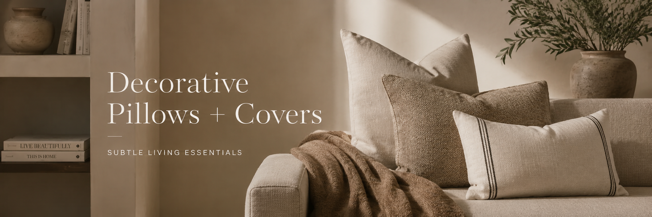 Neutral decorative pillow covers styled on a sofa with soft textures in a warm, refined home setting