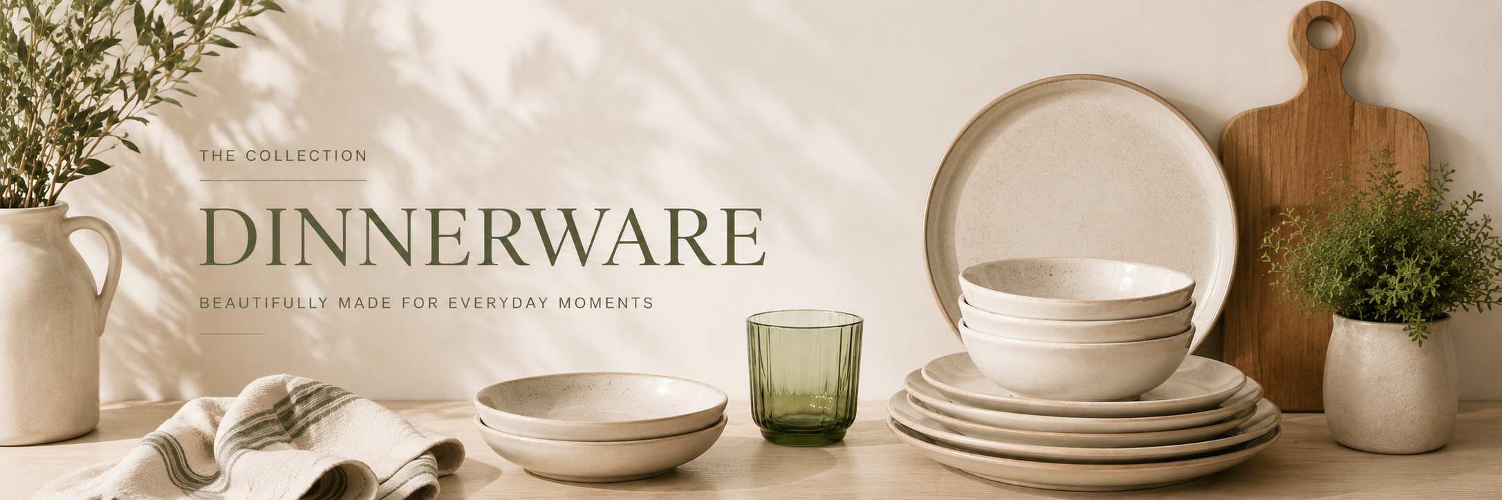 Neutral dinnerware including plates and bowls styled on a warm table with natural textures and soft light