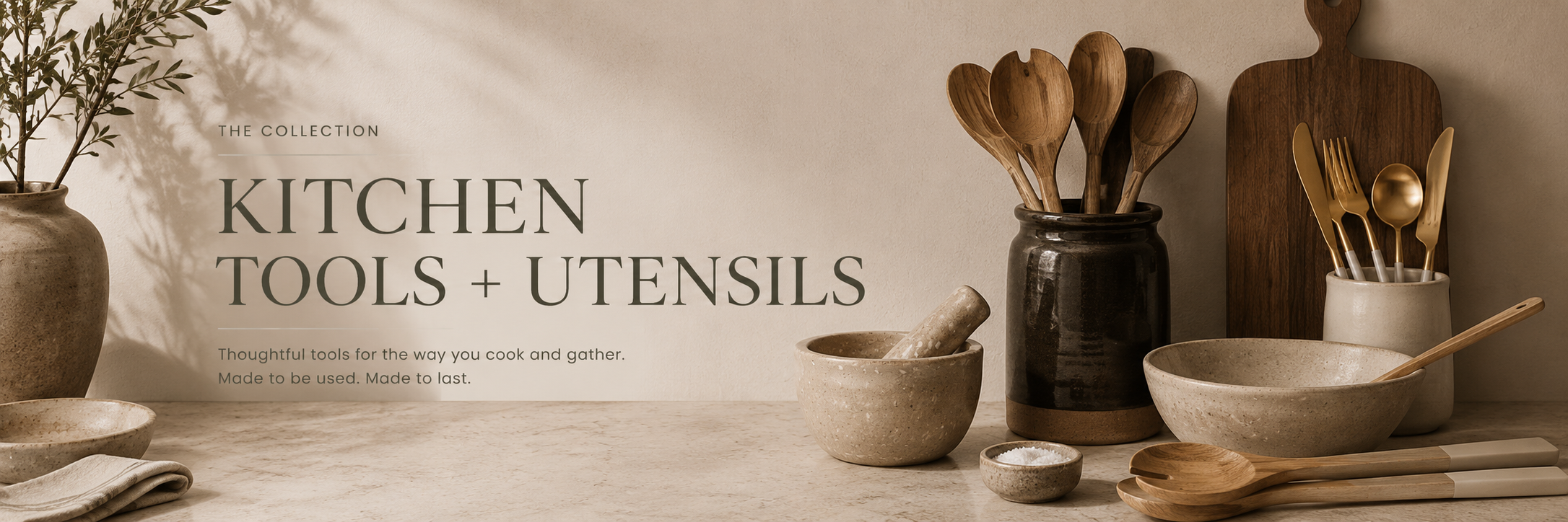 Neutral kitchen tools and utensils in wood and ceramic, styled on a warm, minimal countertop