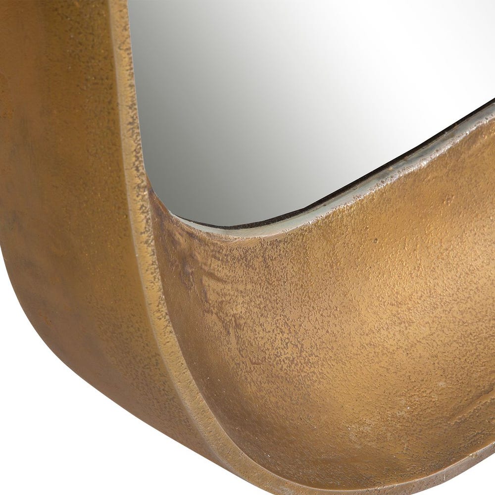 Close-up of textured brass mirror frame