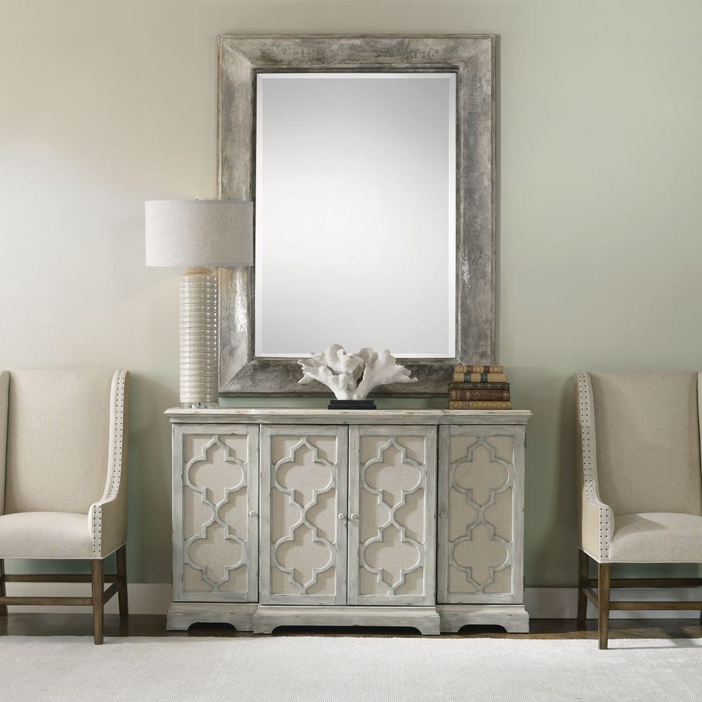 Gray cabinet styled beneath a mirror